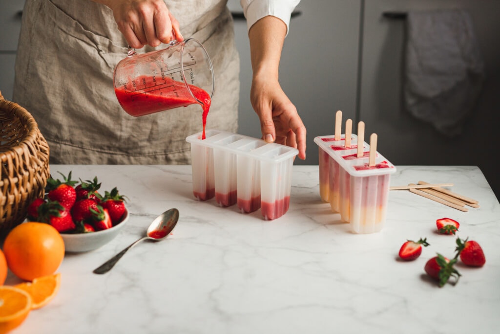 Image of a chef pouring fruit juice into popsicle molds