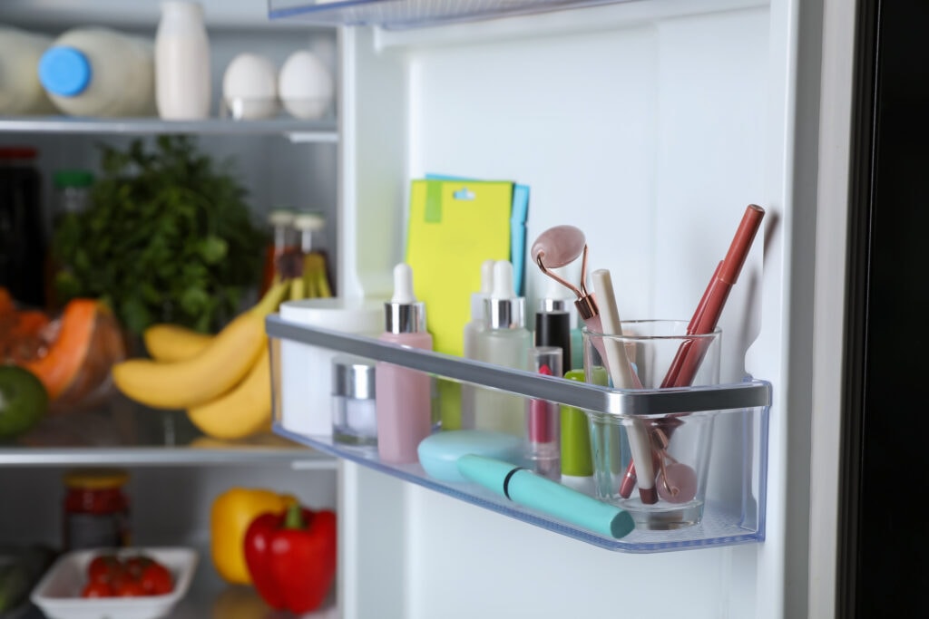 Collection of makeup products on a shelf in a fridge