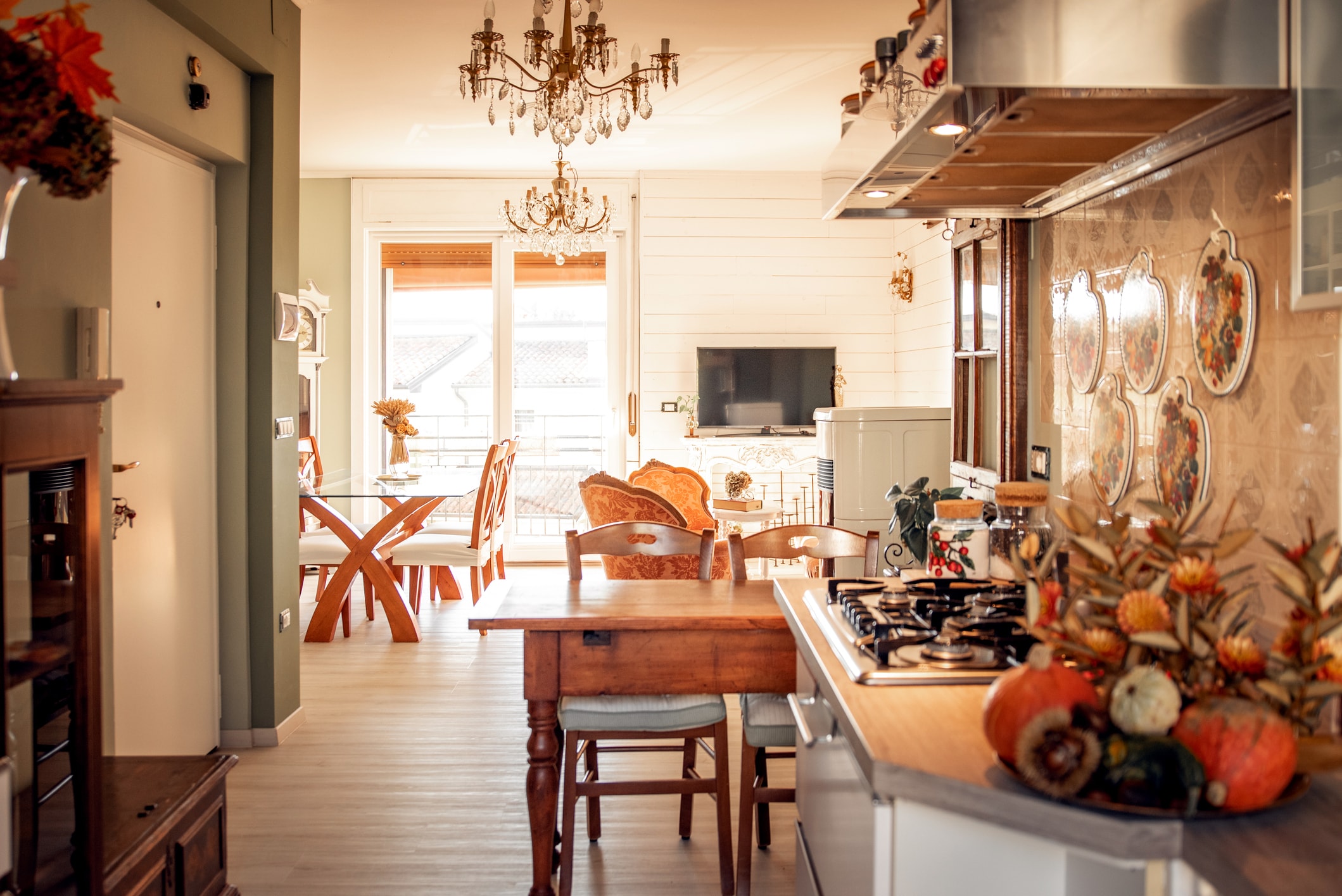 Bright, open-concept kitchen and dining area featuring wood finishes, decorative lighting, and seasonal accents.
