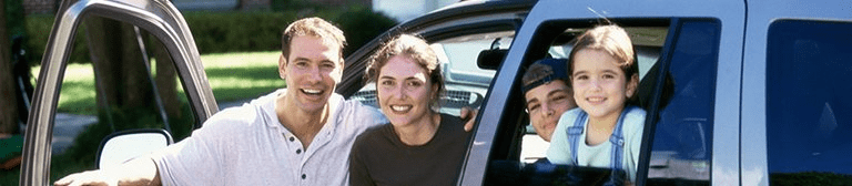 a man and a woman with their two kids in a car