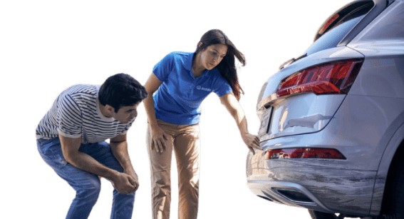 a man and woman with a blue shirt accessing the car damage