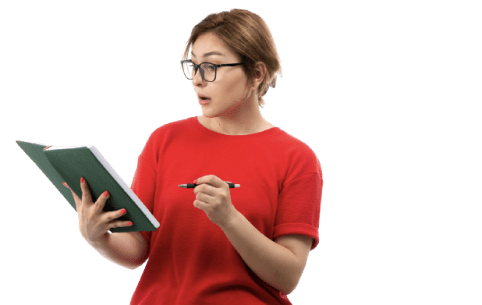 a woman wearing glasses in a red t-shirt holding a book and a pen