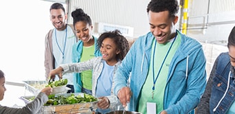 a group of adults and a child serving food