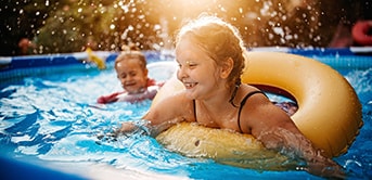 two children playing in a pool