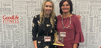 two women standing together with the Goodlife award