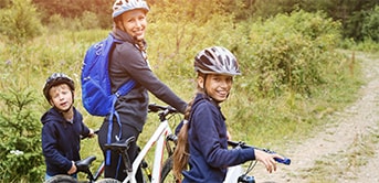 a woman and her two children on their bikes