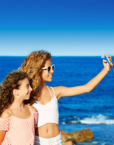 People taking pictures near the ocean