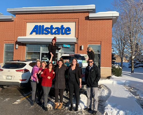 a group of Allstate employees standing in front of their Allstate agency